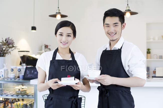 Couple of cafe owners standing in coffee shop — Stock Photo