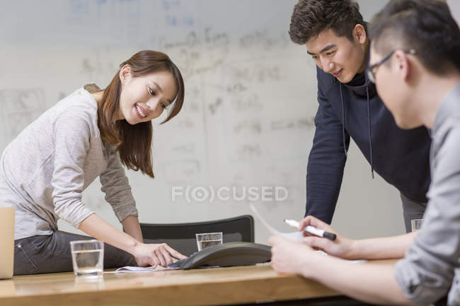 Chinese co-workers having teleconference in meeting room — Stock Photo
