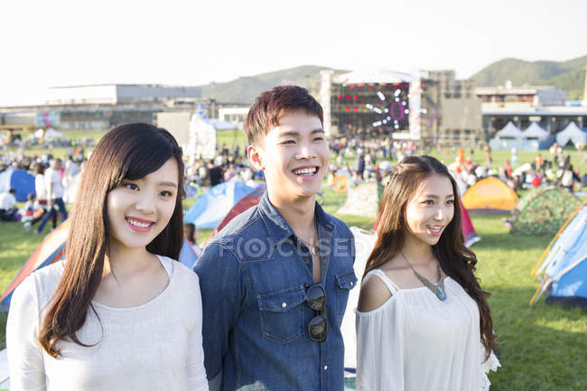Chinese friends standing at music festival — Stock Photo