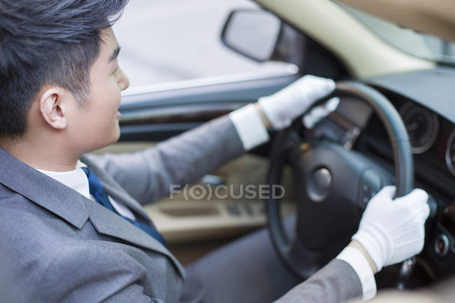 Chinese chauffeur driving car, close-up — Stock Photo