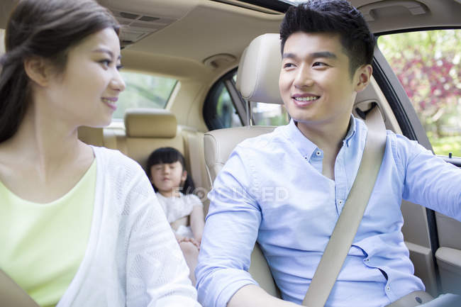 Chinese family sitting in car — Stock Photo