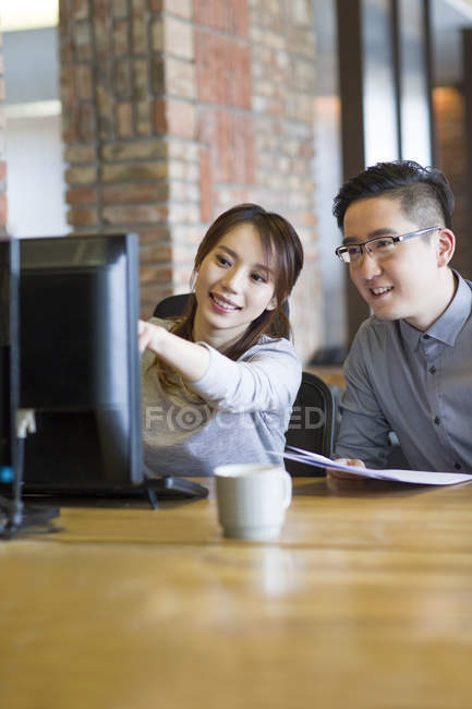 Chinese IT workers using computer in office — Stock Photo