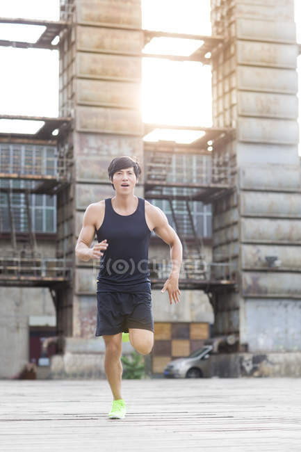 Chinese jogger running on street — Stock Photo