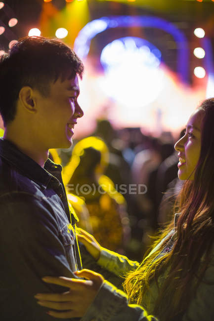 Chinese couple standing face to face at music festival — Stock Photo