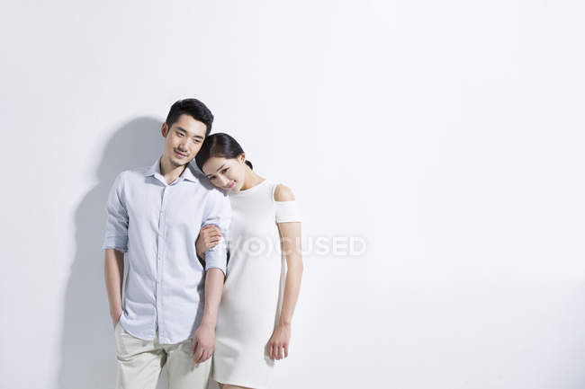Chinese woman holding man and smiling — Stock Photo