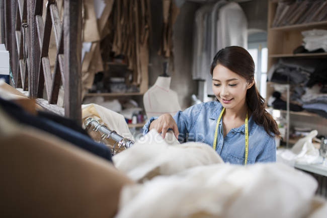Chinese fashion designer working in shop — Stock Photo