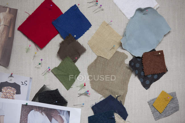 Different fabric swatches on pin board — Stock Photo