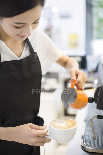 Barista cinese che fa il cappuccino nel caffè — Foto stock
