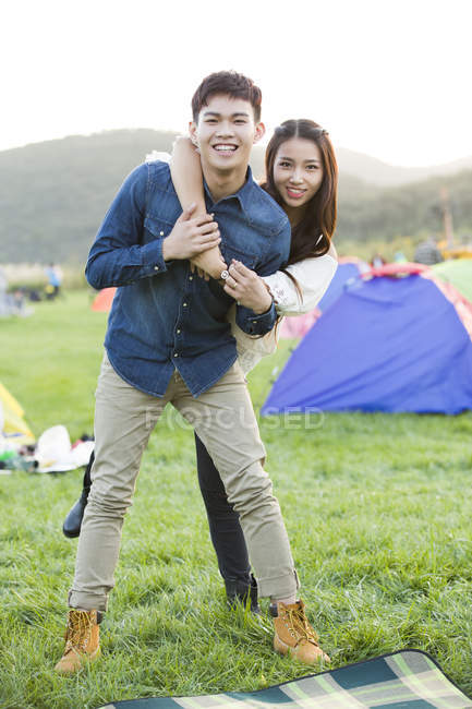 Chinese couple posing on festival lawn — Stock Photo