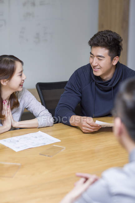 Chinese office workers talking in meeting room — Stock Photo