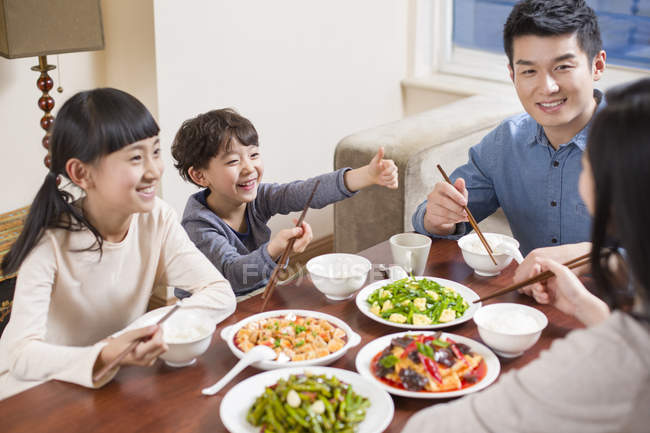Chinese Family Having Dinner At Table Together Brother Father 