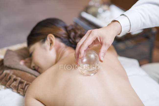 Chinese woman receiving vacuum cupping treatment — Stock Photo