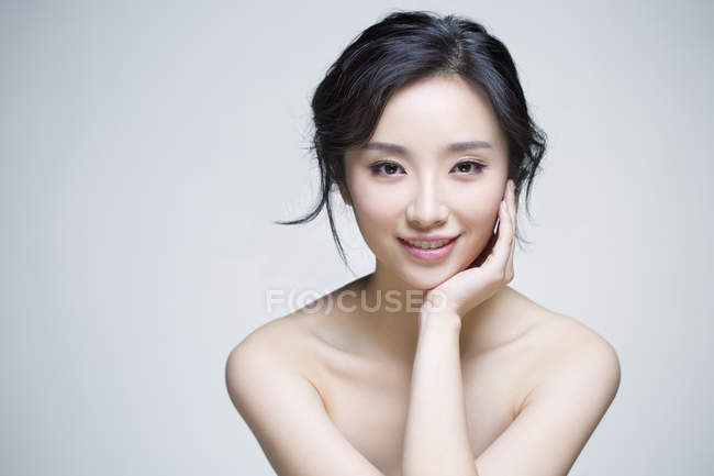 Chinese woman posing with hand on chin — Stock Photo