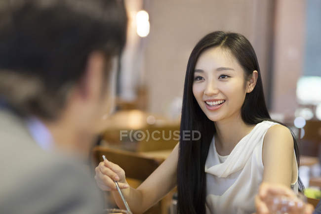 Chinese woman having dinner with friends — Stock Photo