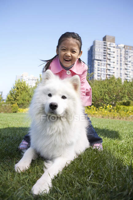 Young Chinese girl and her dog — Stock Photo