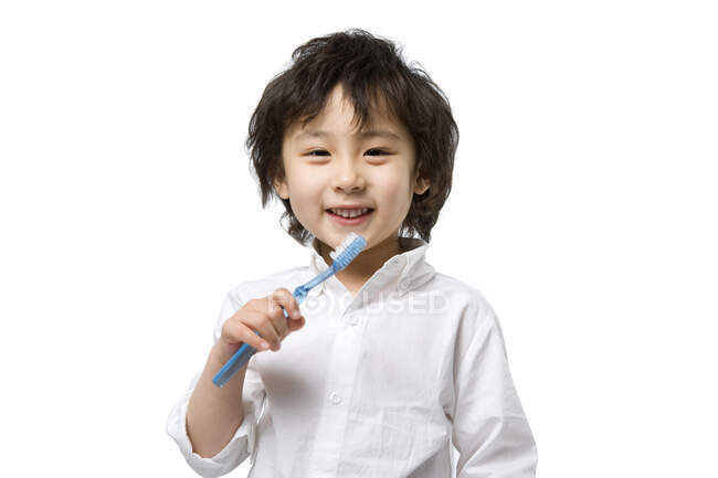 Petit garçon chinois heureux avec brosse à dents — Photo de stock