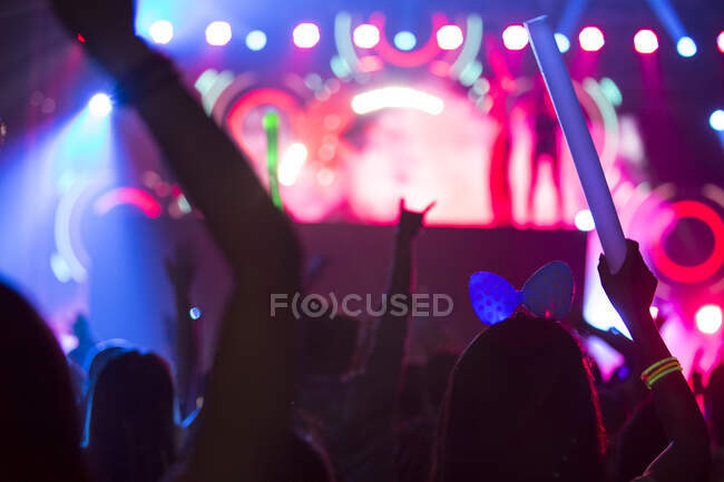 People silhouettes with illuminated stage, music festival in Beijing, China — Stock Photo