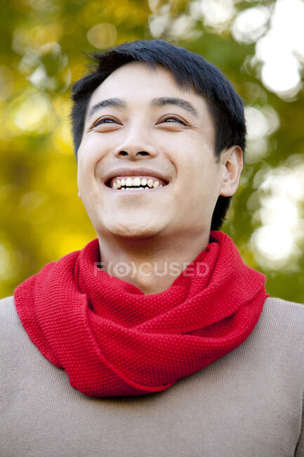 Young Chinese man in a park in autumn — Stock Photo