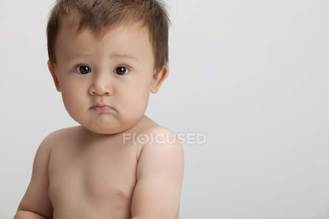 Studio shot of a frowning Chinese baby boy — Stock Photo