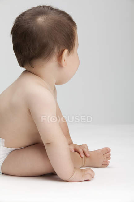 Studio shot of a cute Chinese baby boy looking away — Stock Photo
