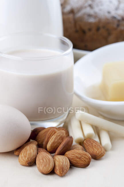 Nuts, eggs and dairy products in ceramic dishes — Stock Photo