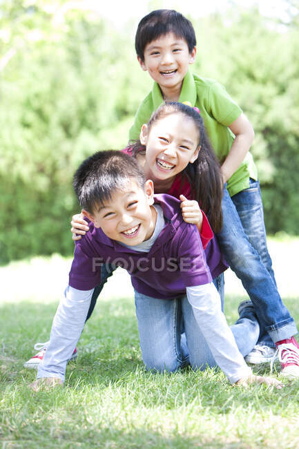 Portrait of Chinese children playing in park — Stock Photo