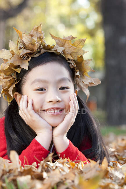 Китаянка с короной из осенних листьев — стоковое фото