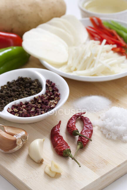 Ingredients and spices on wooden board, close up shot — Stock Photo