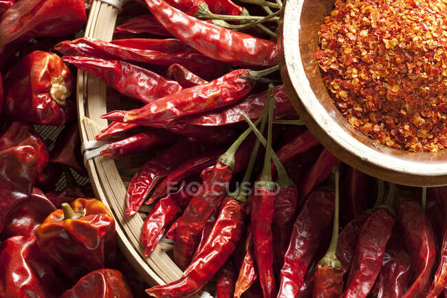 Close-up of dried Chili Peppers and pile of grated spice — Stock Photo