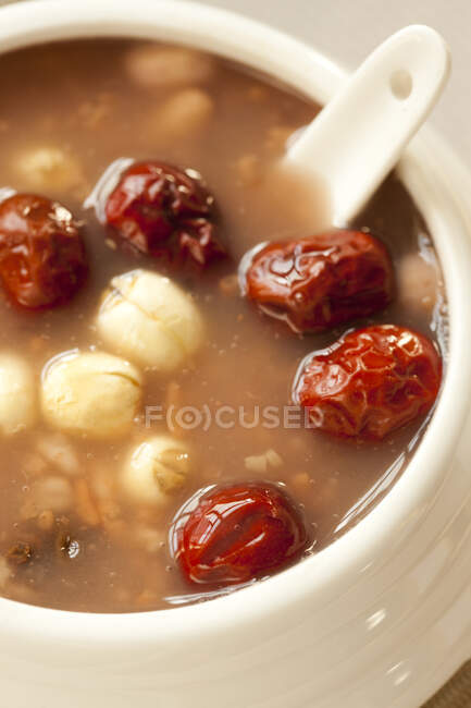 Eight ingredient porridge in bowl with spoon, close up shot — Stock Photo