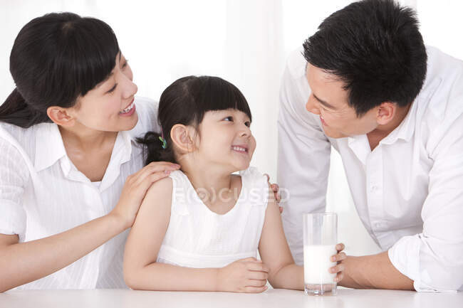 Healthy Chinese family and milk — Stock Photo