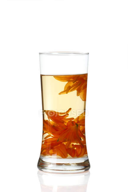 Glass of lily tea isolated on white background — Stock Photo