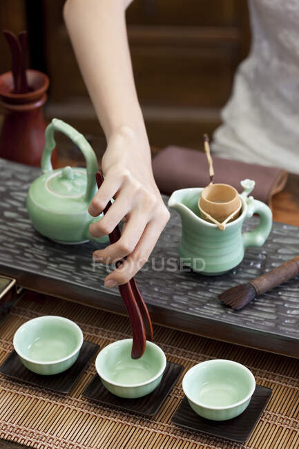 Recortado disparo de la mujer realizando ceremonia del té - foto de stock