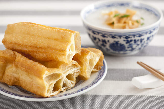 Chinese food, rice porridge and youtiao served on table — Stock Photo