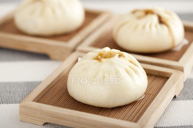 Chinese food steamed buns on wooden plates — Stock Photo