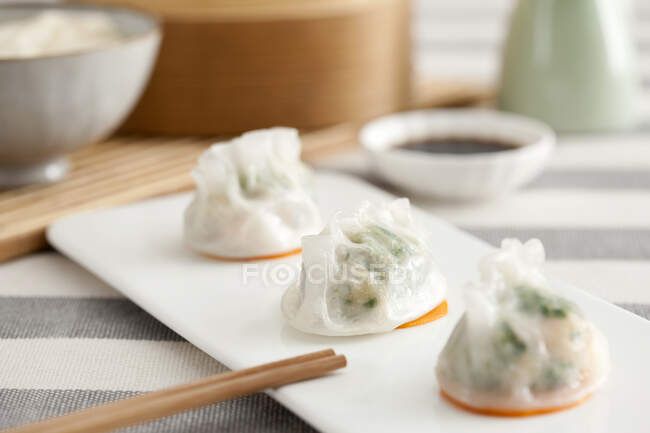 Traditional Chinese rice shrimp dumplings served on plate with chopsticks — Stock Photo