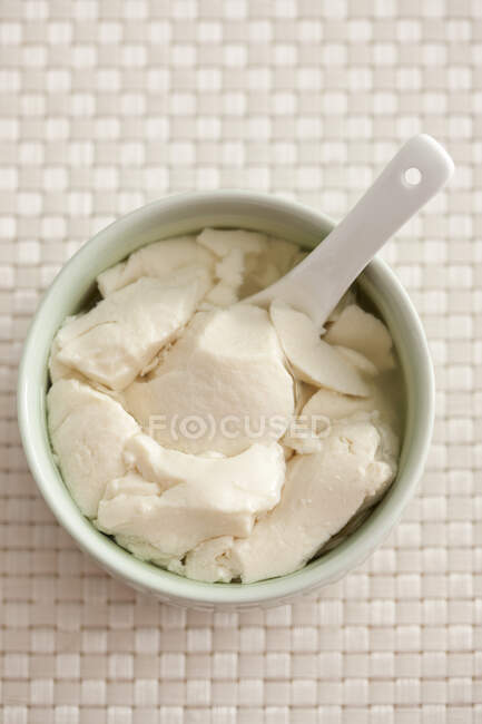Traditional Chinese breakfast, soy curd jelly in bowl with spoon — Stock Photo