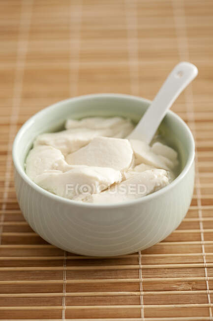 Traditional Chinese breakfast, bean curd jelly in bowl with spoon — Stock Photo