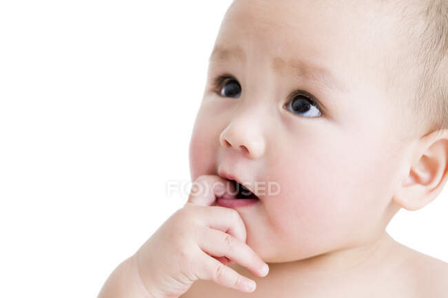Cute Chinese baby boy hand in mouth — Stock Photo