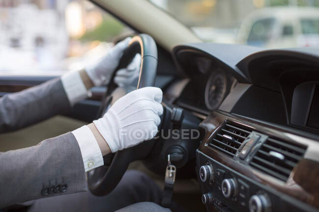 Chinese chauffeur driving car — Stock Photo