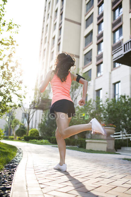 Happy young Chinese woman exercising in the morning — Stock Photo