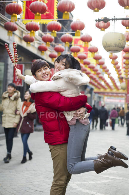 Young Chinese couple with candied haw berries celebrating Chinese New Year — Stock Photo