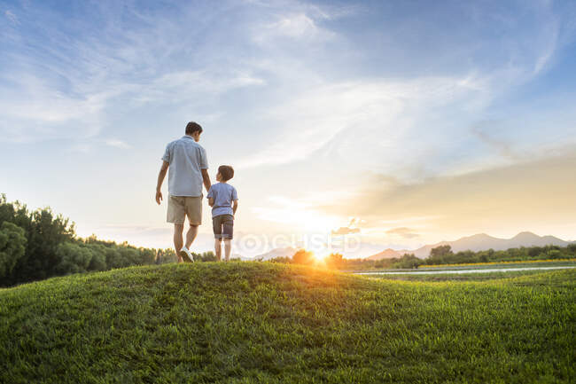 Chinese father and son on meadow — Stock Photo