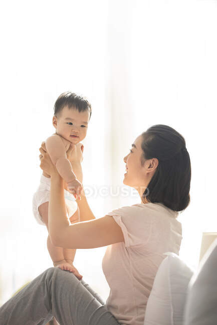 Молодая китайская мама держит своего ребенка — стоковое фото