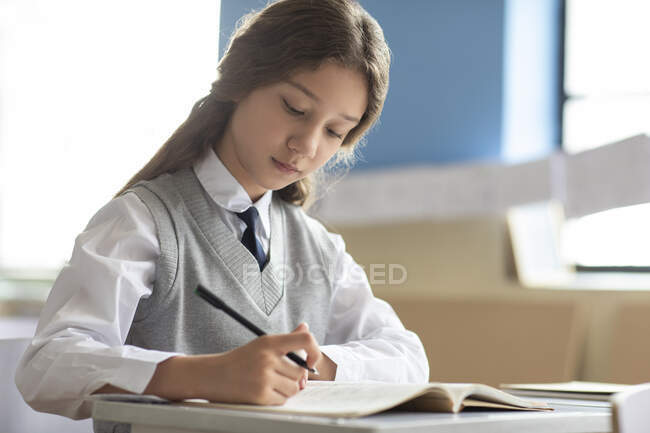 Little girl learning in classroom — Stock Photo