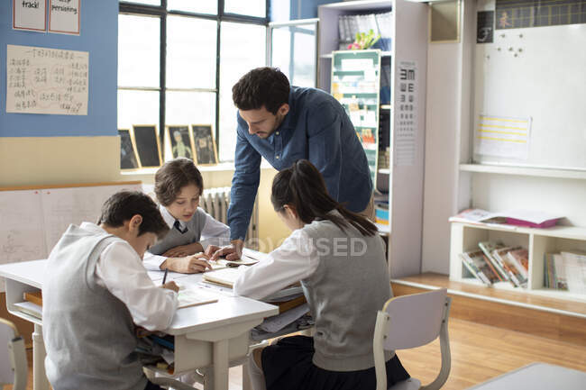 Young teacher teaching a class — Stock Photo
