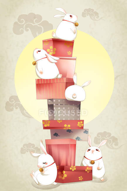 Stacked gift boxes and rabbits with bell rings — Stock Photo