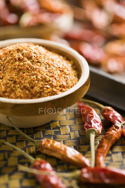 Dried chili peppers and seeds in bowl — Stock Photo