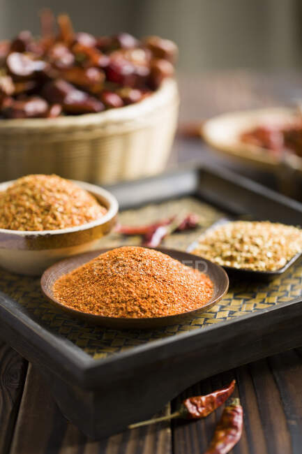 Chili pepper spices in bowls, close up shot — Stock Photo
