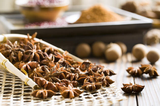 Dried Star anises spice in wooden scoop and on table — Stock Photo